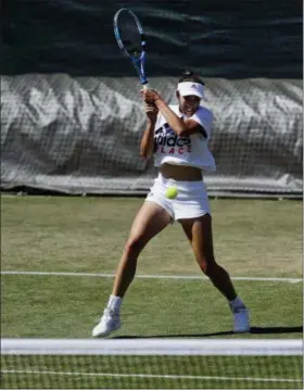  ?? BEN CURTIS— ASSOCIATED PRESS ?? Defending women’s singles champion Garbine Muguruza of Spain practices ahead of the start of the Wimbledon Championsh­ips in London on June 30.