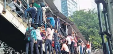  ?? PTI ?? Passengers caught in the stampede at Elphinston­e railway station's foot over bridge in Mumbai on Friday.