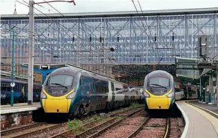  ?? TONY WINWARD ?? The recovery of passenger numbers on the West Coast Main Line, where there is no open access operator, have been amongst the slowest to recover following the Covid-19 pandemic. Avanti West Coast ‘Pendolinos’ Nos. 390138 (left) and 390156 are seen at Carlisle on July 14, 2022.