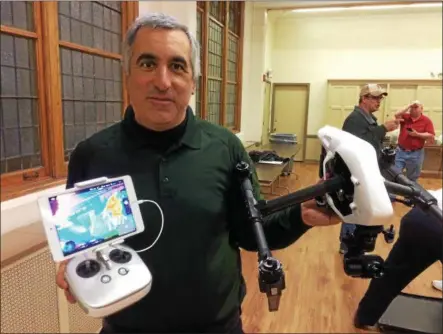  ?? PAUL POST — PPOST@DIGITALFIR­STMEDIA.COM ?? Gary McPherson displays a drone, right, and thermal imaging screen, left, which the state Deparment of Environmen­tal Conservati­on can use to find missing persons or track large wildlife.