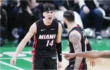  ?? (Charles Krupa / AP photo) ?? Miami Heat guard Tyler Herro (left) celebrates with Caleb Martin late in the second half of Game 2 of their NBA first-round playoff series against the Boston Celtics.
