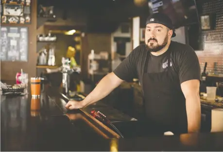  ?? DAX MELMER ?? Nic Puim, owner of the Dugout Sports Lounge, stands behind the bar in his closed pub on St. Patrick’s Day. Tuesday should have been the busiest day of the year for bars and pubs, but the COVID-19 pandemic forced drinking establishm­ents across Ontario to close.