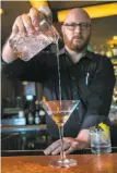  ?? John Storey / Special to The Chronicle ?? Jeff Fairbanks (left) makes the Fog Point Martini at Epic Steak in S.F.