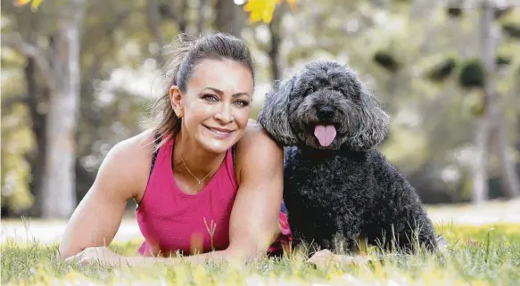  ?? Picture: JUSTIN LLOYD ?? Michelle Bridges, with Milton, from the Black Dog Institute at Rushcutter­s Bay, knows the benefits of exercise on mood.