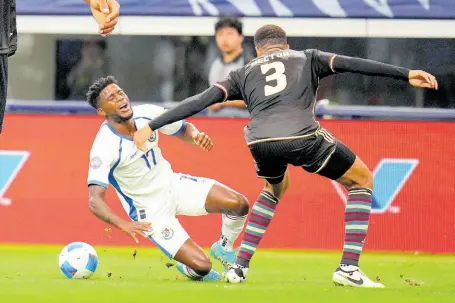  ?? ?? Panama’s Jose Fajardo (17) is knocked to the ground by Jamaica’s Michael Hector (3) as they work to control possession in the first half of a Concacaf Nations League third-place play-off at the AT&T Stadium in Arlington, Texas on Sunday.