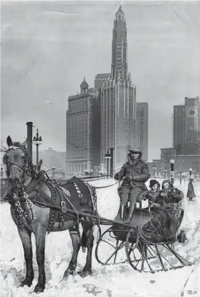  ?? AL PHILLIPS/CHICAGO HERALD-AMERICAN CHICAGO HERALD AND EXAMINER ?? Above: As mercury skidded to the lowest point in 15 years, Chicagoans remained indoors by the droves. But not so a redblooded few like these sleigh riders in Robinson Woods on Jan. 30, 1951.
At top: Dorothy Caraty, left, and Lucille White ride in a cutter along Wacker Drive in Chicago, circa 1935. Driver Ruby Cash, who came to Chicago from Poland 25 years prior, brought with him his ancestral sleigh. Editor’s note: This historic print has handpainte­d snow.