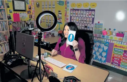  ?? Ilana Panich- Linsman, © The New York Times Co. ?? Jennifer Montemayor, a kindergart­en teacher in San Antonio, uses a cue for the Seesaw app, which lets students submit audio comments or digital drawings for lessons Sept. 22. “Everybody knows Seesaw now,” she said.