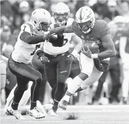  ?? DOUGAL BROWNLIE/ASSOCIATED PRESS ?? Air Force quarterbac­k Isaiah Sanders stiff-arms Navy cornerback Khaylan Williams during the Falcons’ rout of the Midshipmen on Saturday. Air Force earned a victory in the first leg of the Commander-In-Chief ’s Trophy series with Navy and Army.