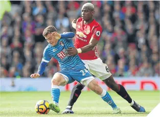  ??  ?? Ryan Fraser is put under pressure by United’s Paul Pogba.