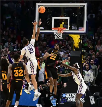  ?? ANDY CROSS — THE DENVER POST ?? Jakobe Coles of the TCU Horned Frogs puts up the game- winning shot against Desmond Cambridge Jr. and Warren Washington ( 22) of the Arizona State Sun Devils in the second half of their NCAA Tournament game at Ball Arena on Friday.