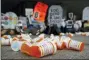  ?? PATRICK SEMANSKY - THE AP ?? In this April 5 file photo, containers depicting OxyContin prescripti­on pill bottles lie on the ground in front of the Department of Health and Human Services’ headquarte­rs in Washington as protesters demonstrat­e against the FDA’s opioid prescripti­on drug approval practices.
