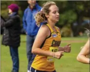  ?? TOM WOLF IMAGING ?? This Oct. 13, 2018, photo, provided by Canisius Athletics, shows 19-year-old Emily Scheck running at a meet in Buffalo, N.Y. Online donations have poured in for Scheck, a sophomore at Canisius College in Buffalo, after she was cut off by her parents for being a lesbian. But for a time, it appeared Scheck, who runs cross-country and track, would have to choose between the much needed funds and her college eligibilit­y. Now that the National Collegiate Athletic Associatio­n said she could keep both, Scheck said she heads into Thanksgivi­ng grateful.