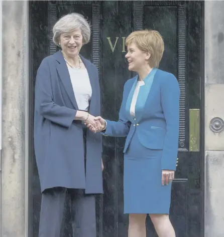  ??  ?? 0 It’s all smiles on the steps of Bute House, but the divide between Nicola Sturgeon’s Scotland and England is widening