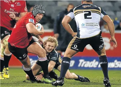 ?? Picture: AFP ?? POLISHED: Lions loosehead prop Corne Fourie, left, evades a Joe Powell tackle during Friday night’s Super Rugby clash against the Brumbies