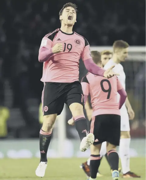  ??  ?? Scotland’s Chris Martin, who put Martin Skrtel under pressure and forced him to turn the ball into the Slovakia net, celebrates.