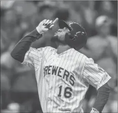  ?? Tom Lynn / The Associated Press ?? Milwaukee’s Domingo Santana celebrates as he scores on a solo home run during the seventh inning of Friday’s game in Milwaukee.