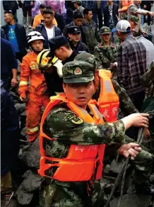  ?? AP ?? Emergency workers search for survivors Photograph: Chinatopix via