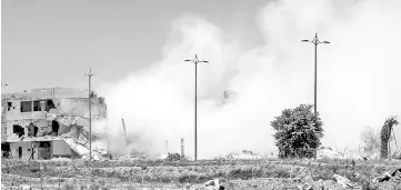  ??  ?? Smoke rising in the aftermath of the Syrian government forces’ demolition of a tunnel formerly used by rebels in the capital Damascus’ northeaste­rn suburb of Qaboun. — AFP photo