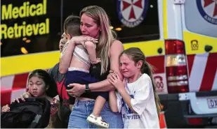  ?? AP ?? People are led out from the Westfield Shopping Centre, where multiple people were stabbed in Sydney, Australia, on Saturday. Six people — five women and a man — died in the attack before the 40-year-old assailant was shot dead by police.