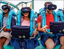  ??  ?? NOW YOU SEE IT: Riders enjoy the virtual-reality on Kraken Unleashed