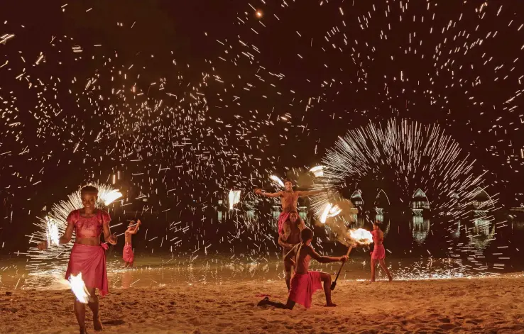  ?? ?? Fiji Marriot Resort Momi Bay entertaine­rs perform a fire dance during the Sunset Series on April 9, 2023.