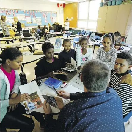  ?? LARRY WONG ?? Students in a class for new Canadians at St. Alphonsus School.