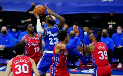  ?? AP Photo/Mat Slocum ?? Los Angeles Lakers’ LeBron James (23) goes up for a shot against Philadelph­ia 76ers’ Dwight Howard (39), Matisse Thybulle (22), Shake Milton (18) and Furkan Korkmaz (30) during the first half of an NBA basketball game, Wednesday, Jan. 27, 2021, in Philadelph­ia.
