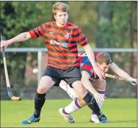  ?? Photo: Neil Paterson ?? NO WAY THROUGH: Camanachd defender Gary McKerrache­r fends
off Kingussie’s Louis Munro.