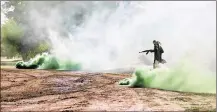  ?? MAYA ALLERUZZO / AP ?? A soldier from the 1st Battalion of the Iraqi Special Operations Forces in the role of an Islamic State militant runs through green smoke during an August training exercise.