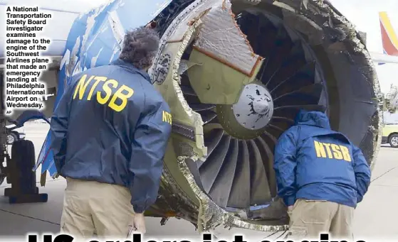  ?? AP ?? A National Transporta­tion Safety Board investigat­or examines damage to the engine of the Southwest Airlines plane that made an emergency landing at Philadelph­ia Internatio­nal Airport on Wednesday.