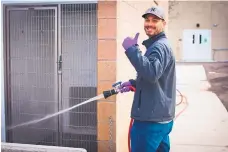  ?? COURTESY OF CITY OF ALBUQUERQU­E’S OFFICE OF CIVIC ENGAGEMENT ?? An Animal Welfare general shelter volunteer helps clean out a kennel.