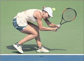  ?? ANDRES KUDACKI – THE ASSOCIATED PRESS ?? Simona Halep hits a returns during her firs-round U.S. Open match against Kaia Kanepi on Monday. Halep, the No. 1 women’s seed, lost 6-2, 6-4.