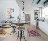  ??  ?? The kitchen and living room show how high ceilings and copious light create a loft-like feel.