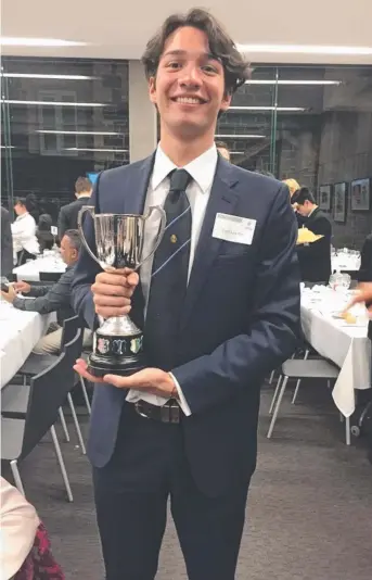  ?? Picture: SUPPLIED ?? Josef Lew Fatt receives the Joshua Hardy Trophy from Melbourne Grammar at his valedictor­y ceremony