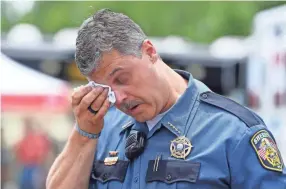  ??  ?? Dickson County Sheriff Jeff Bledsoe wipes a tear as he talks about Sgt. Daniel Baker, who was shot and killed Wednesday, May 30. Authoritie­s are searching for a suspect, according to the Tennessee Highway Patrol.