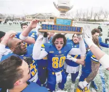  ?? LIAM RICHARDS ?? Saskatoon Hilltops receiver John Brown lifts the Paul Schwann Memorial Cup as the team celebrate their victory over the Edmonton Huskies in the Prairie Football Conference championsh­ip game Oct. 27.