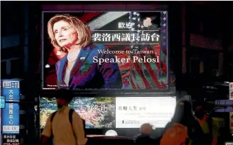  ?? AP ?? People in Taipei walk past a billboard welcoming US House Speaker Nancy Pelosi to Taiwan. Pelosi’s controvers­ial visit is part of a broader trend of more regular visits by lawmakers from liberal democracie­s.