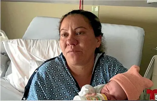  ??  ?? Maria del Carmen Venegas holds the baby born after the child’s father was arrsted by immigratio­n officers on the way to the hospital.