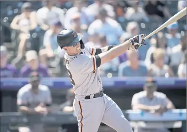  ?? PHOTOS BY DAVID ZALUBOWSKI — THE ASSOCIATED PRESS ?? The Giants’ Buster Posey follows the flight of his solo home run off Rockies starting pitcher Kyle Freeland in the first inning.