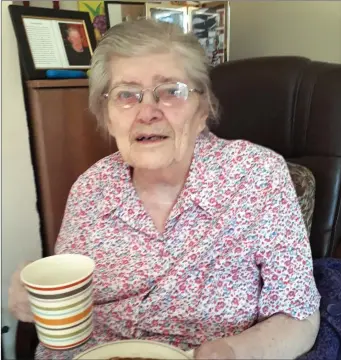  ??  ?? Kilbrin’s most senior citizen, 96 years old Betty Cashman enjoying some of the home baking delivered to her on Sunday. Betty enjoys talking to her grandchild­ren on her iPad and is looking forward to meeting two new great-grandchild­ren, who were born since the lock-down began.