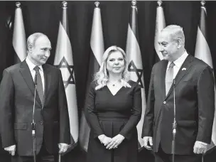  ?? HEIDI LEVINE/ASSOCIATED PRESS ?? Israeli Prime Minister Benjamin Netanyahu and his wife, Sarah, stand Thursday with President Vladimir Putin of Russia at Netanyahu’s official residence in Jerusalem.