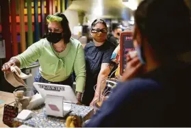  ?? Amy Osborne / Special to The Chronicle ?? Katey McKee (left), with wife Sharon Ratton, take a customer’s order in their newly opened cafe, Milk SF. They are enthusiast­ic proponents of the city’s new permitting process.