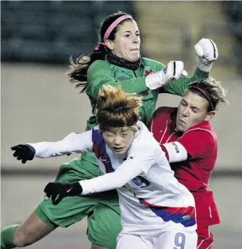  ?? JASON FRANSON/ THE CANADIAN PRESS ?? South Korea’s Ga Eul Jeon and Canada’s Christine Sinclair crash into goalkeeper Stephanie Labbe during a 2013 match. Labbe is one of three goalies on Canada’s World Cup roster.