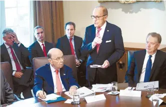  ?? AFP-Yonhap ?? U.S. Secretary of Commerce Wilbur Ross, U.S. Trade Representa­tive Robert Lighthizer, right, and others listen as economic adviser Larry Kudlow, center, speaks before a cabinet meeting at the White House in Washington, D.C., Monday.