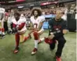  ??  ?? Colin Kaepernick, centre, chose to kneel to respect military veterans without compromisi­ng his protest.