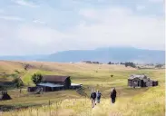  ?? DAN ELLIOTT/ASSOCIATED PRESS ?? Visitors approach a former ranch house and barn during a guided hike on the Rocky Flats National Wildlife Refuge near Denver in August 2017.