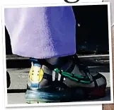  ??  ?? WELL-HEELED: Exclusive trainers with a smiley-face logo cost £1,500 – more than the jacket Iris, right, wore