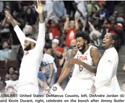  ??  ?? JUBILANT: United States' DeMarcus Cousins, left, DeAndre Jordan (6) and Kevin Durant, right, celebrate on the bench after Jimmy Butler dunked during the second half of an exhibition basketball game against Venezuela on Friday in Chicago. The United...