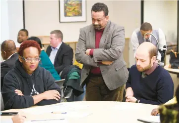  ?? KYLE TELECHAN/POST-TRIBUNE ?? Indiana State Board of Education member Tony Walker listens as visitors discuss at Roosevelt College and Career Academy in Gary on Dec. 16, 2019. Walker died Wednesday.