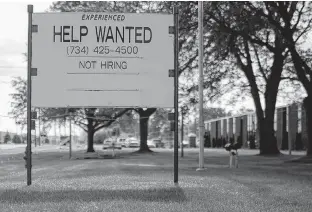  ??  ?? A “Help Wanted” sign reads “Not Hiring” in Livonia, Mich., Oct. 9, 2019.